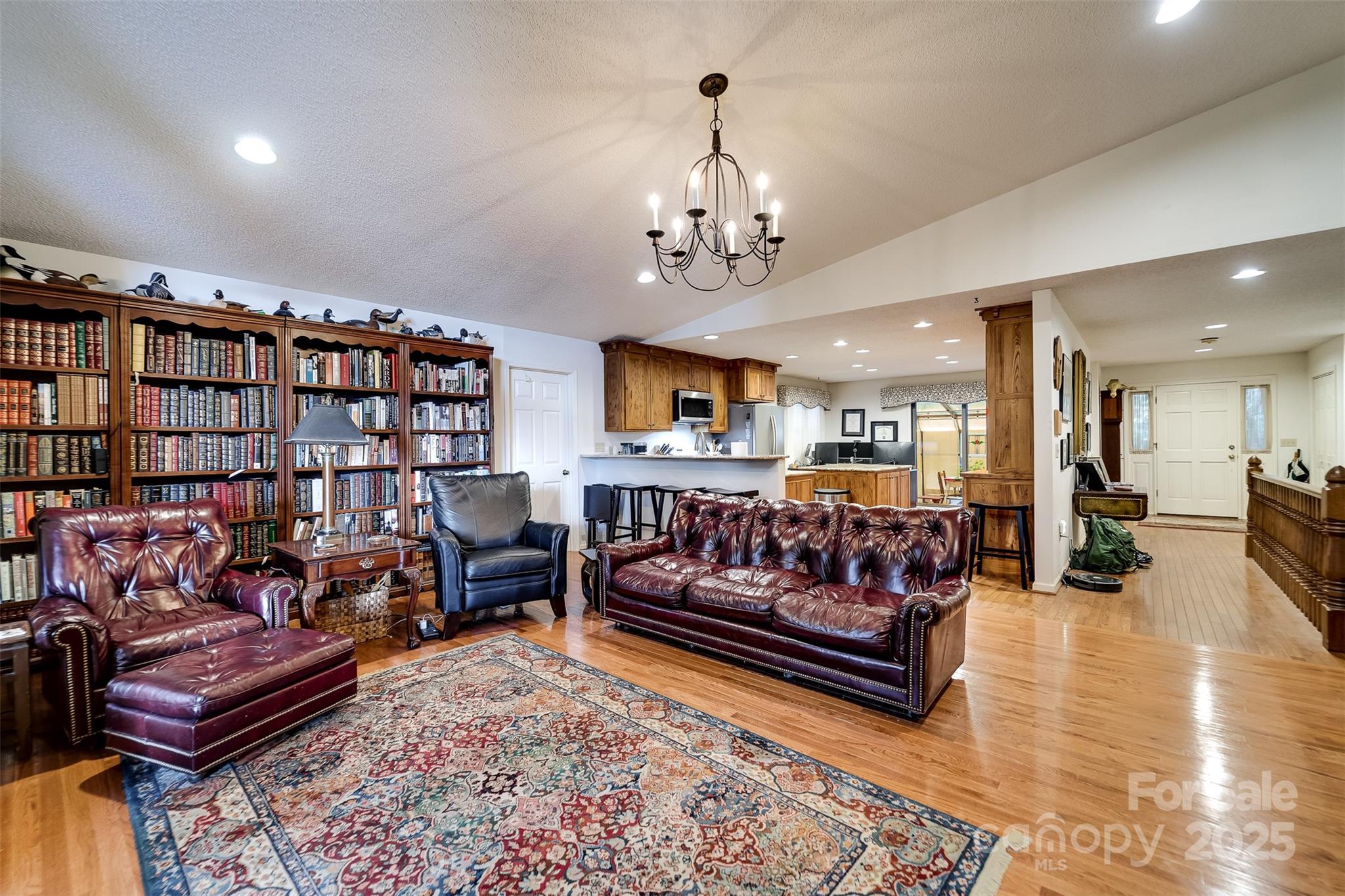 831 Forest Run Road Whittier, NC 28789 - Photo 10 of 29 a living room with furniture a couch and a bookshelf with wooden floor