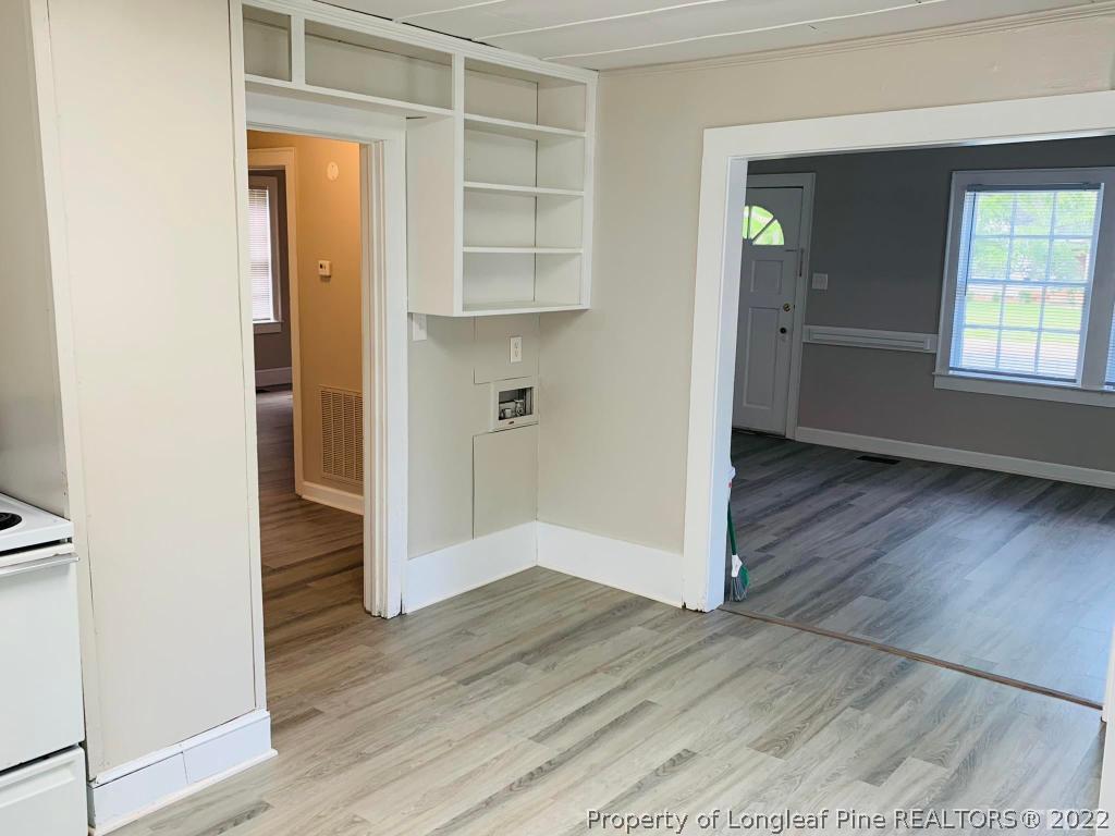 203 Hillsborough Road Carrboro, NC 27510 - Photo 4 of 12 an empty room with wooden floor and closet