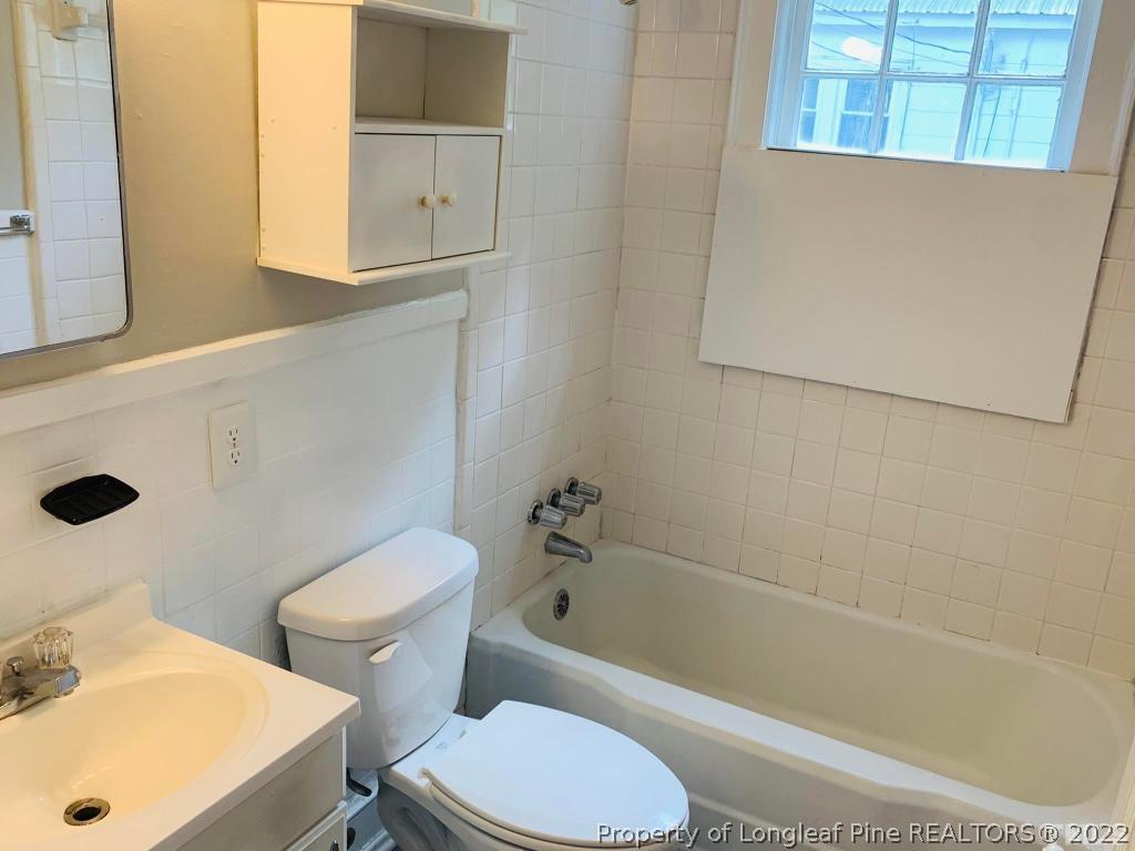203 Hillsborough Road Carrboro, NC 27510 - Photo 10 of 12 a white toilet sitting next to a bath tub