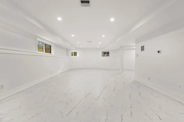 an empty room with a empty space and windows