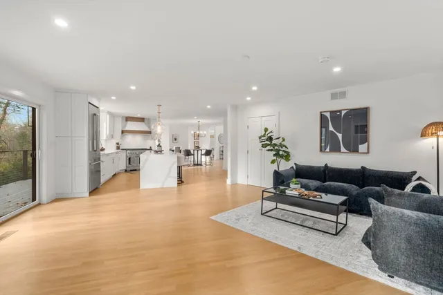 a living room with furniture and kitchen view