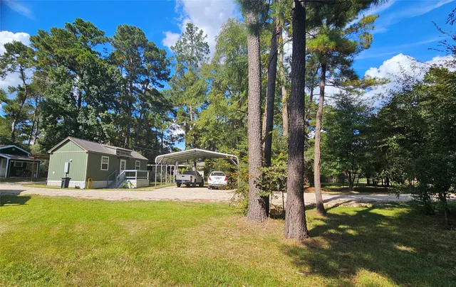 a view of house with outdoor space and swimming pool