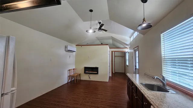 a hallway with a sink and chandelier