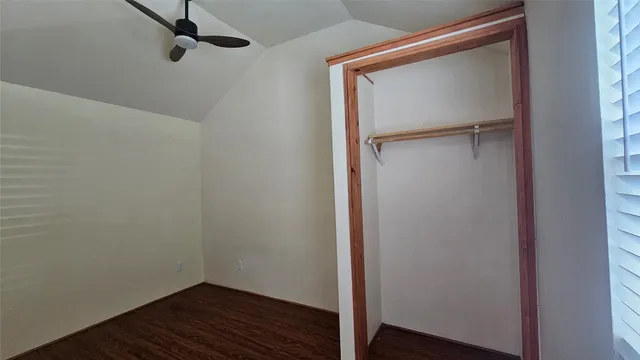 a small space with wooden floor and a window