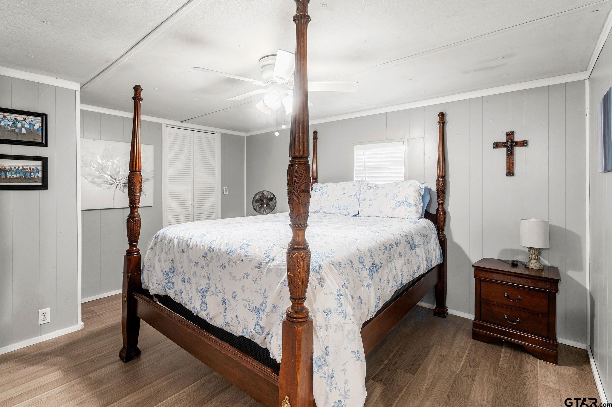 4550 Crabapple Road Gilmer, TX 75645 - Photo 17 of 33 a bedroom with a bed and wooden floor
