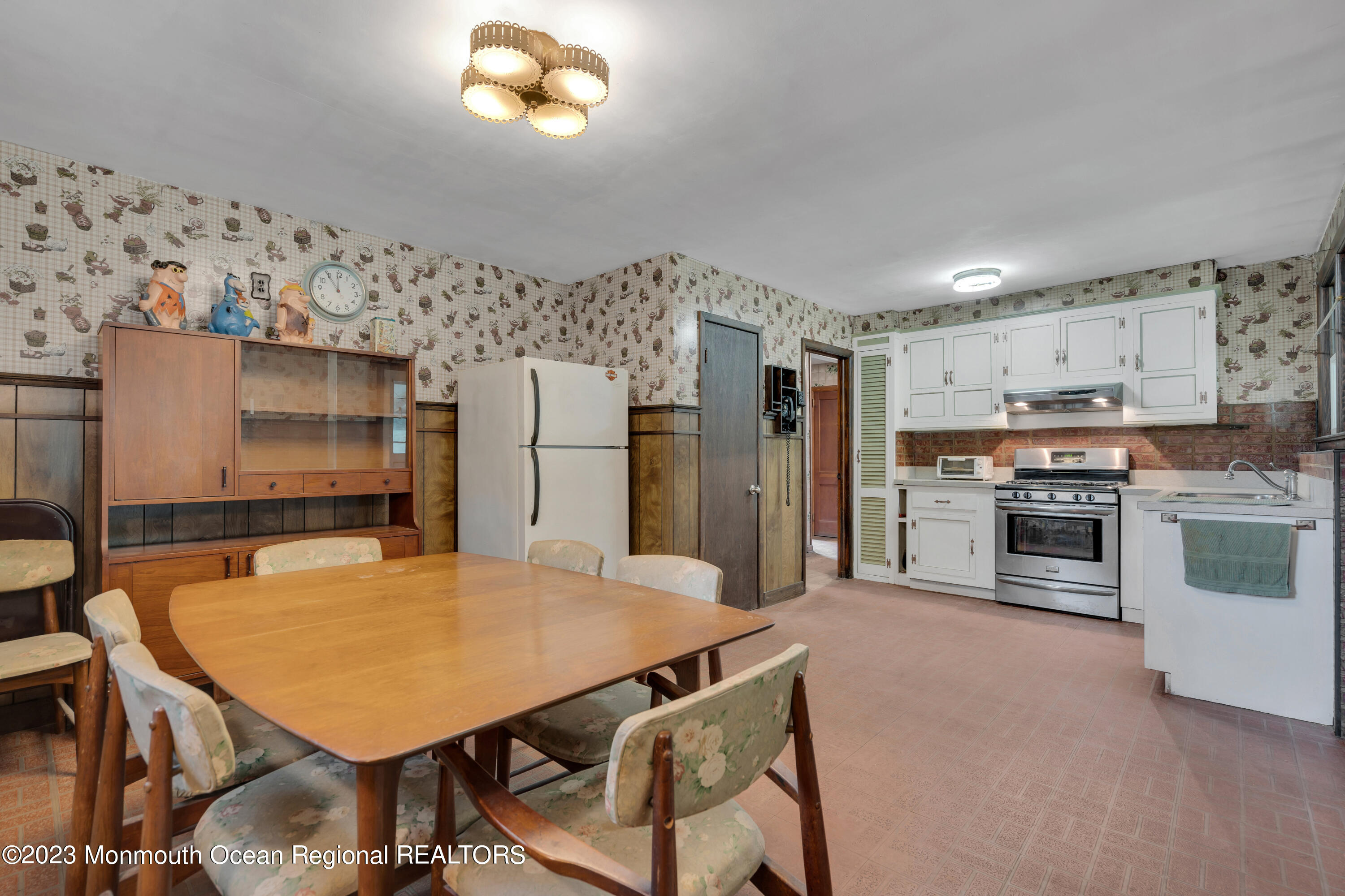 674 Harmony Road Jackson, NJ 08527 - Photo 10 of 43 a kitchen with stainless steel appliances a stove a refrigerator a oven a sink with a dining table and chairs