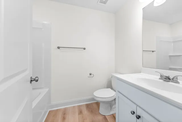 a white toilet sitting next to a bathroom sink