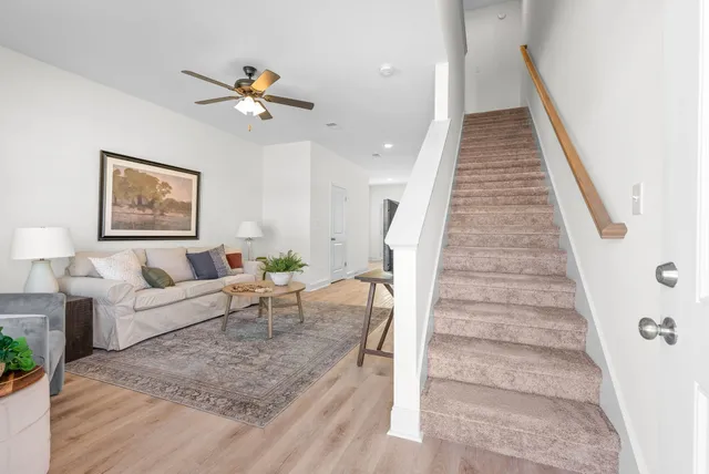 a living room with furniture and a stairs