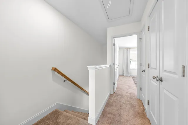 a view of a hallway with a white walls