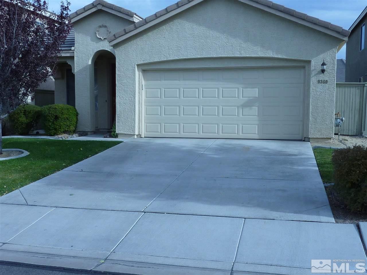 9360 Hummer Court Reno, NV 89521 - Photo 1 of 1 a front view of a house with a yard and garage