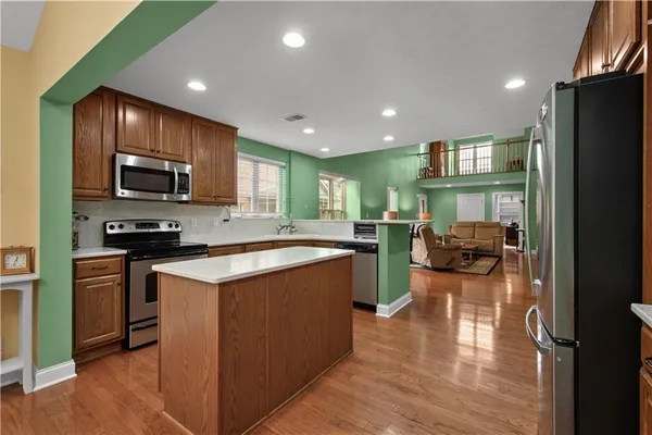 a kitchen with sink refrigerator and microwave