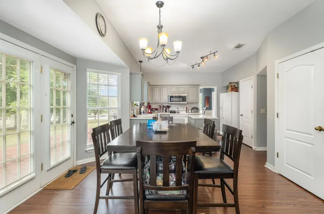 a view of a dining room with furniture window and wooden floor