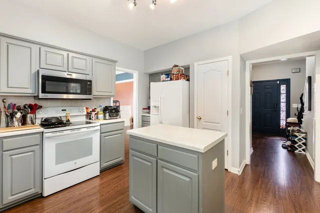 a kitchen with a sink a stove and cabinets