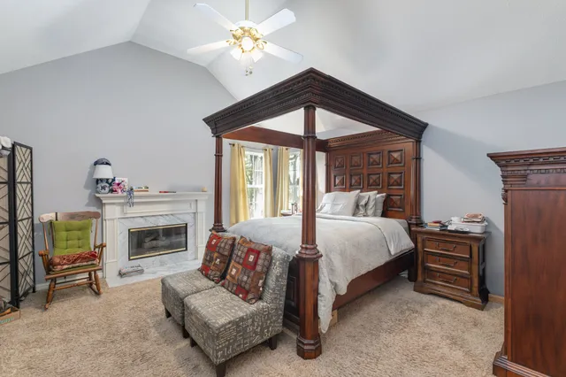 a spacious bedroom with a bed and a fireplace