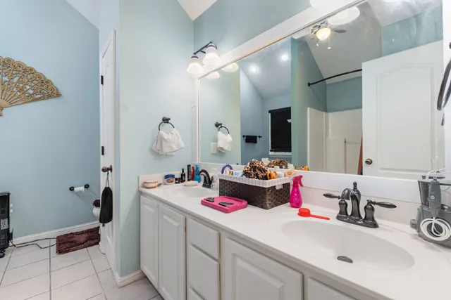 a bathroom with a sink double vanity and a mirror