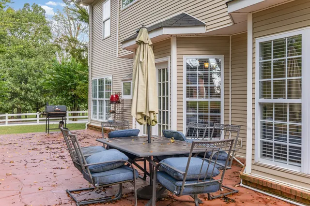 a view of a backyard with table and chairs and potted plants