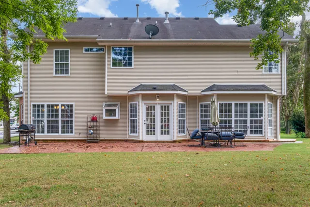 a front view of a house with a yard and outdoor seating