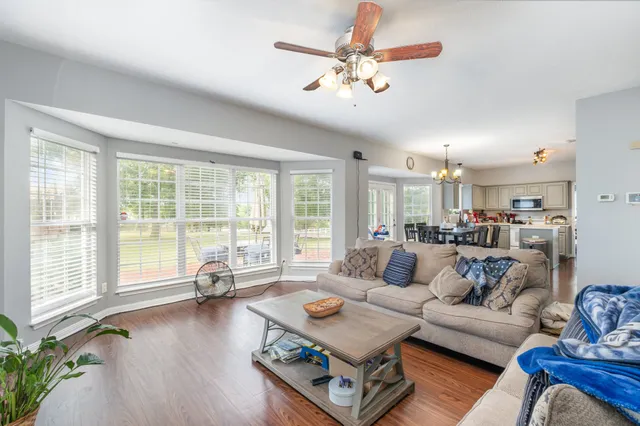 a living room with furniture and floor to ceiling windows