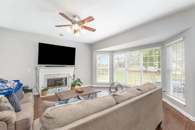 a living room with furniture a fireplace and a flat screen tv