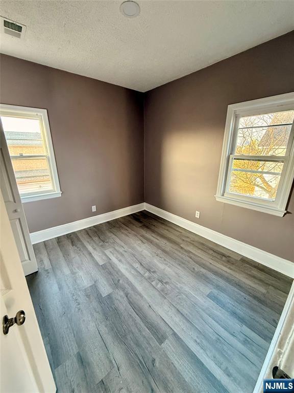 86 Hunter Street Lodi, NJ 07644 - Photo 4 of 15 a view of an empty room with wooden floor and a window