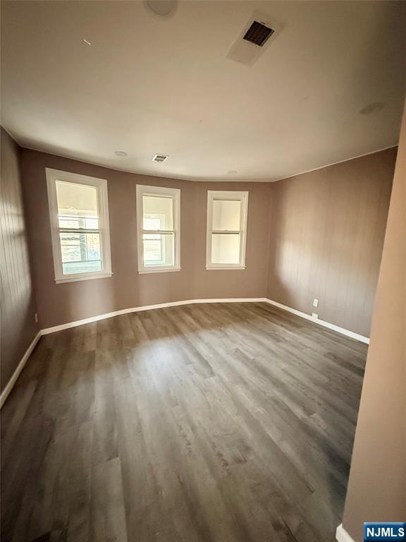 86 Hunter Street Lodi, NJ 07644 - Photo 5 of 15 an empty room with wooden floor and windows