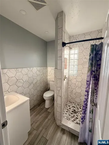 a bathroom with a toilet and a shower