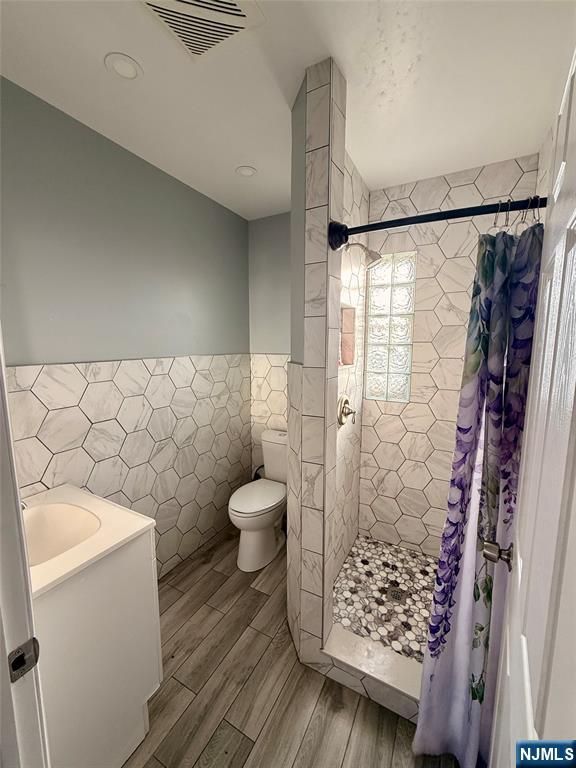86 Hunter Street Lodi, NJ 07644 - Photo 10 of 15 a bathroom with a toilet and a shower