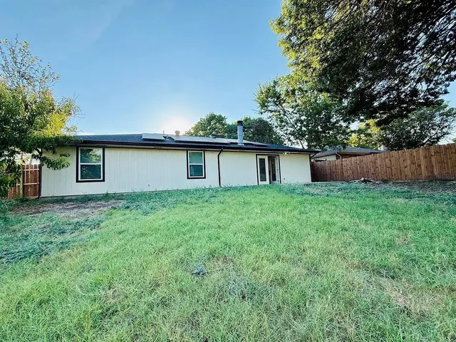 a front view of house with a garden