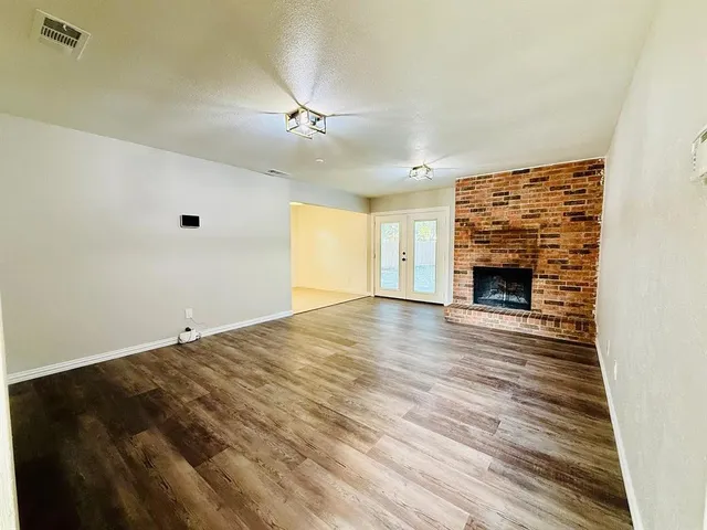 wooden floor in an empty room with a fireplace