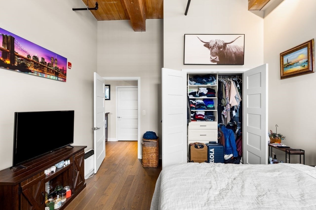 130 John Street, Unit 459 Lowell, MA 01852 - Photo 16 of 42 a view of a living room with clothes and a flat screen tv