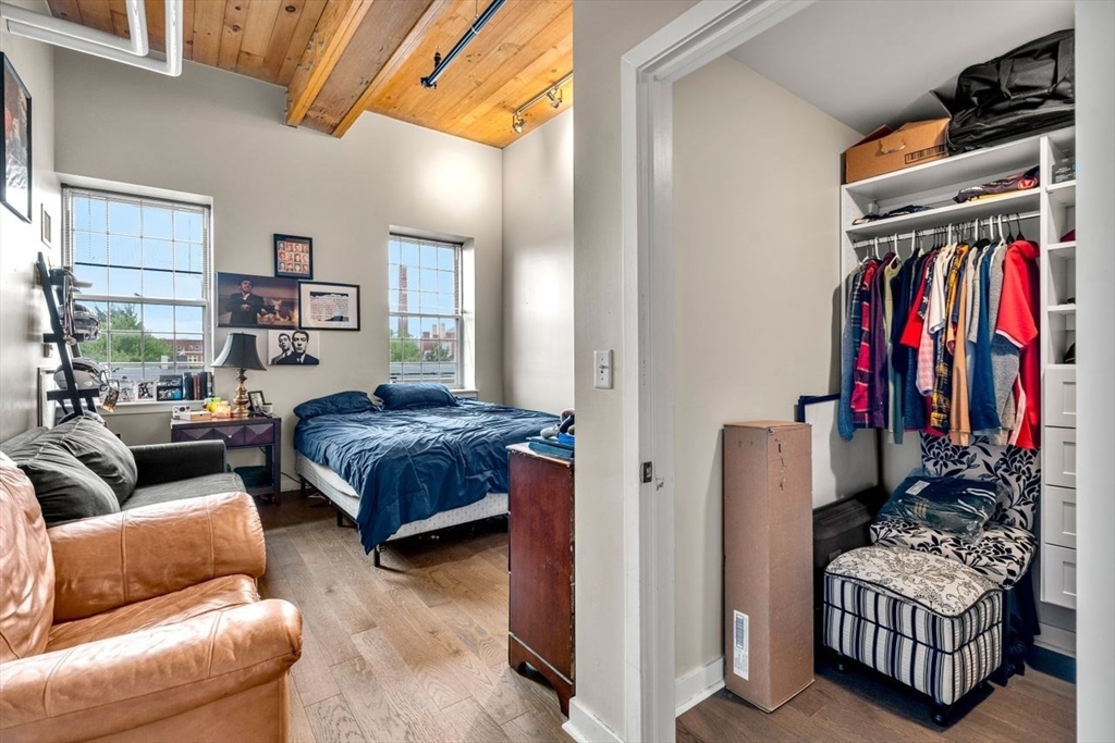 130 John Street, Unit 459 Lowell, MA 01852 - Photo 21 of 42 a bedroom with furniture and a couch