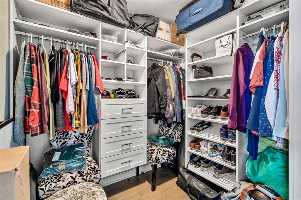 130 John Street, Unit 459 Lowell, MA 01852 - Photo 25 of 42 a view of walk in closet with clothes and shoes
