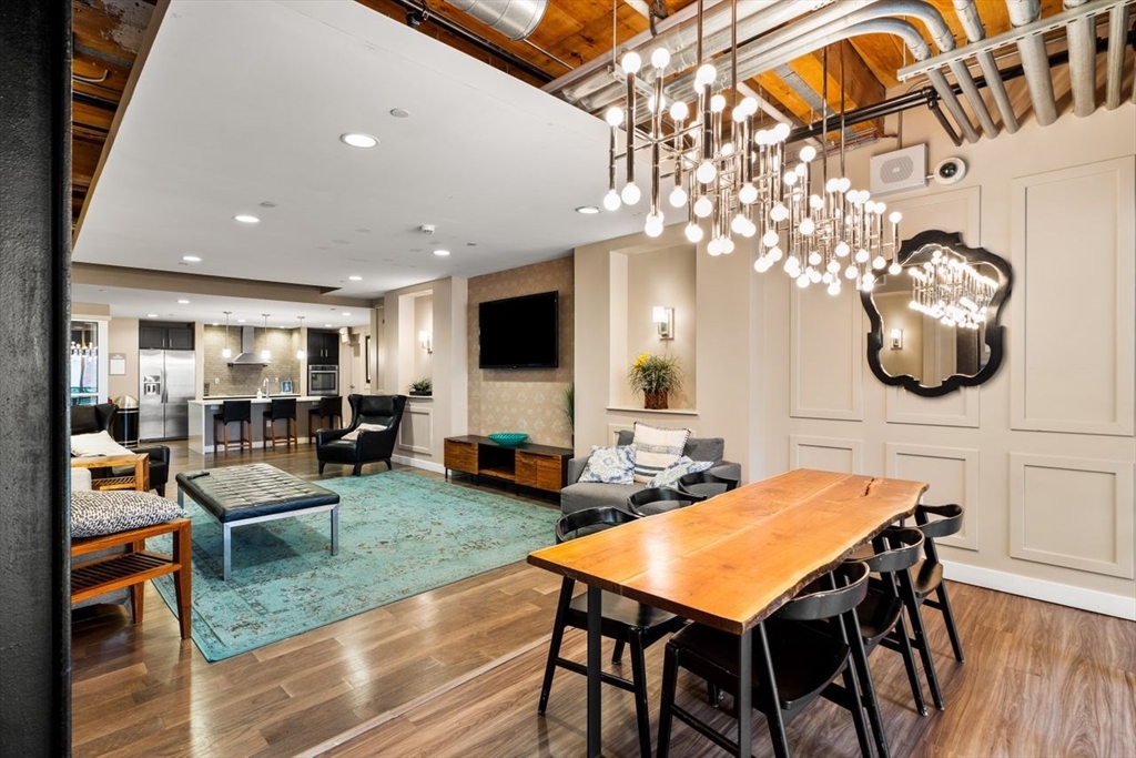 130 John Street, Unit 459 Lowell, MA 01852 - Photo 33 of 42 a view of a dining room with furniture and wooden floor