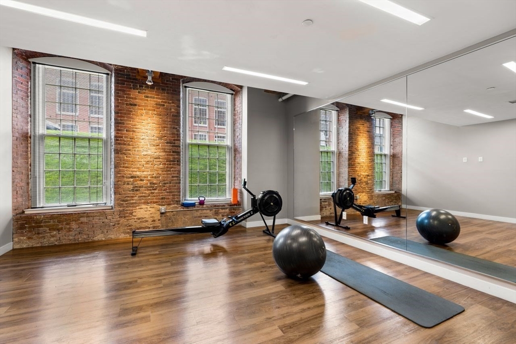 130 John Street, Unit 459 Lowell, MA 01852 - Photo 37 of 42 a room with furniture and two windows