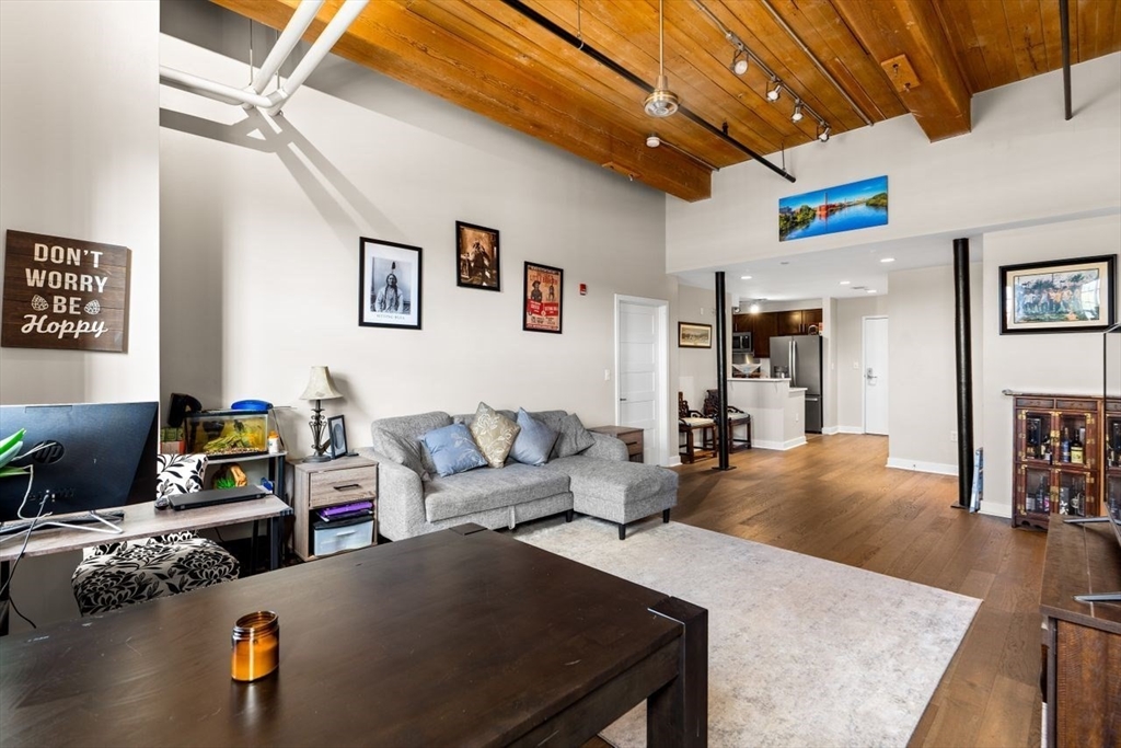 130 John Street, Unit 459 Lowell, MA 01852 - Photo 10 of 42 a living room with furniture and wooden floor