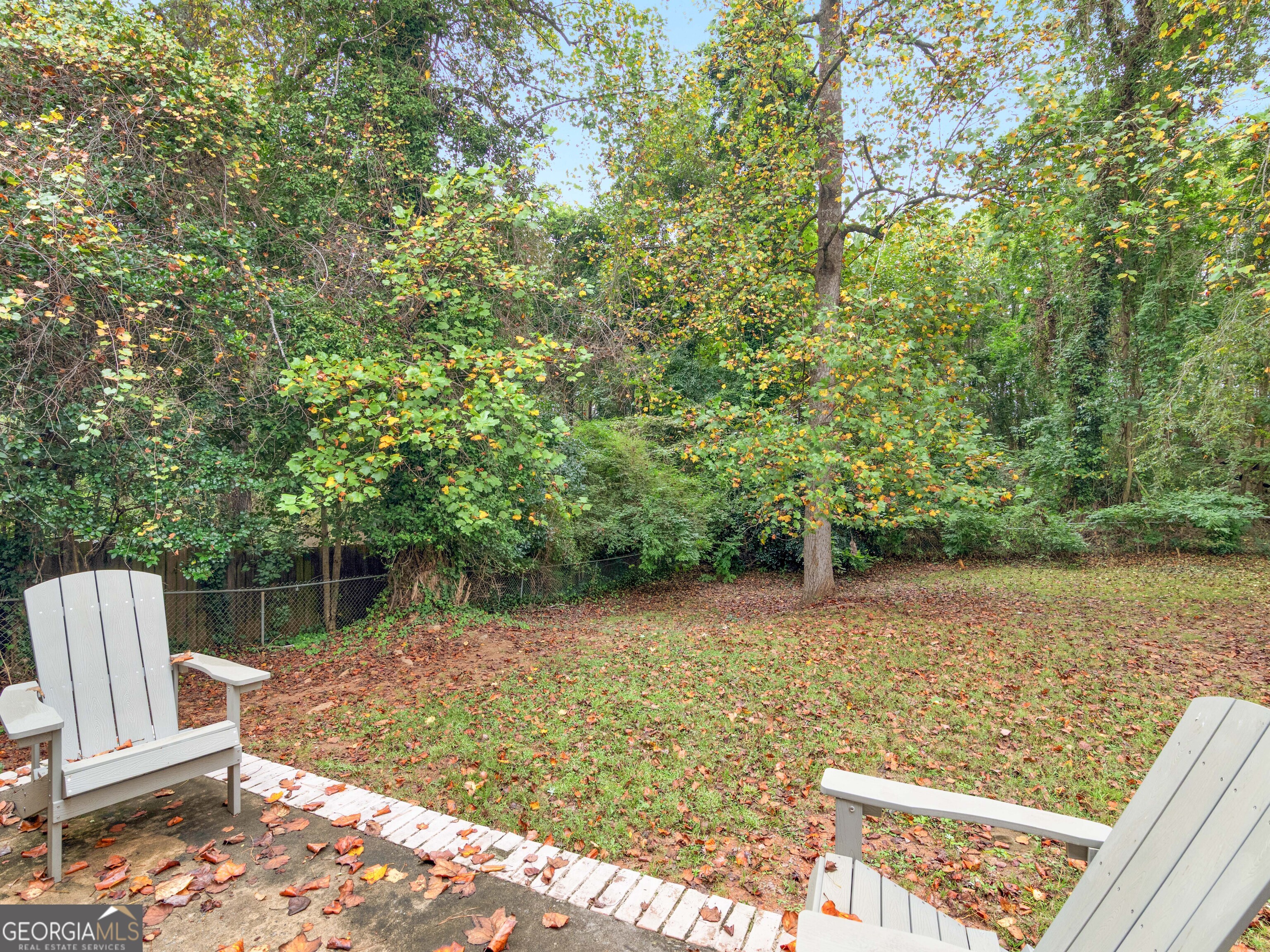262 Rhodes Drive Athens, GA 30606 - Photo 19 of 21 a view of a backyard with wooden fence and trees