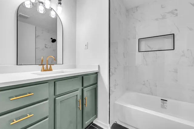 a bathroom with a sink vanity and a mirror