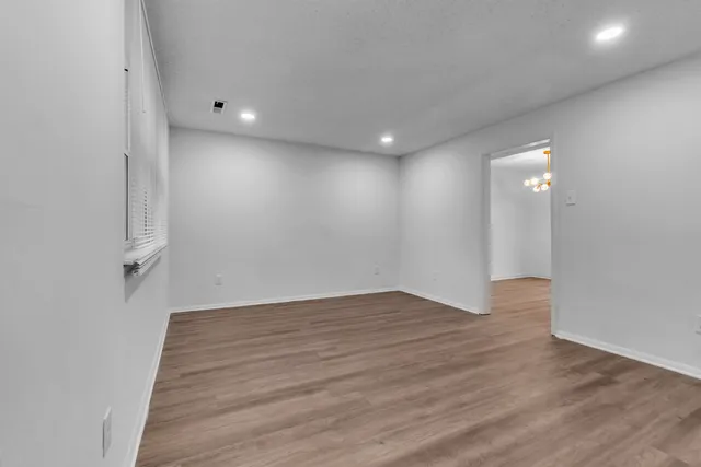 a view of a room with wooden floor