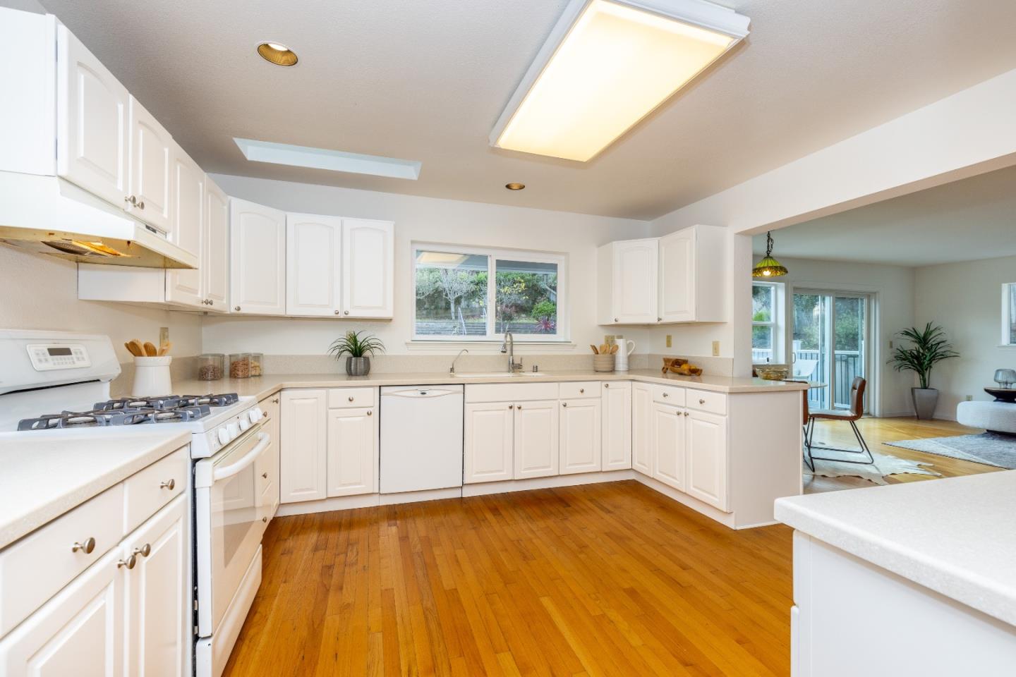 1415 Grand Avenue Pacifica, CA 94044 - Photo 14 of 47 a kitchen with a sink a stove cabinets and wooden floor