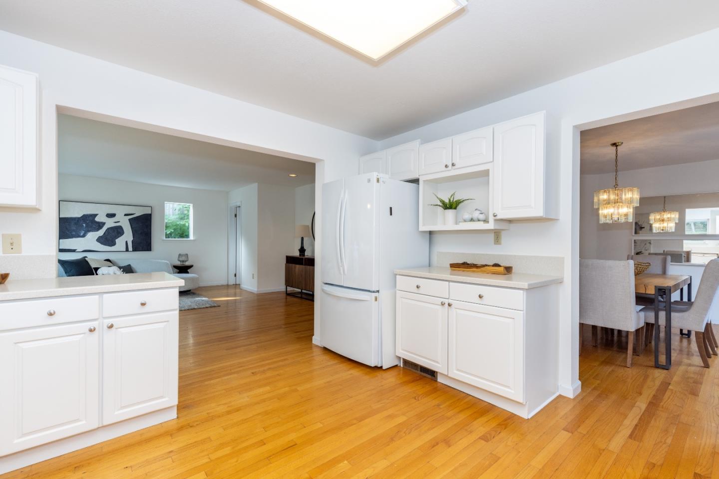 1415 Grand Avenue Pacifica, CA 94044 - Photo 16 of 47 a kitchen with stainless steel appliances a white cabinets and wooden floors
