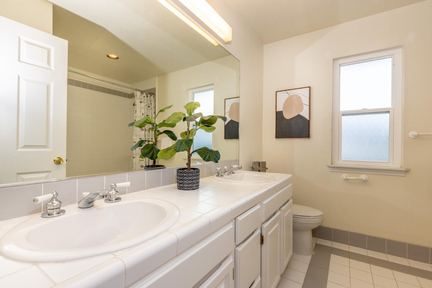 1415 Grand Avenue Pacifica, CA 94044 - Photo 30 of 47 a bathroom with a sink and a mirror with toilet