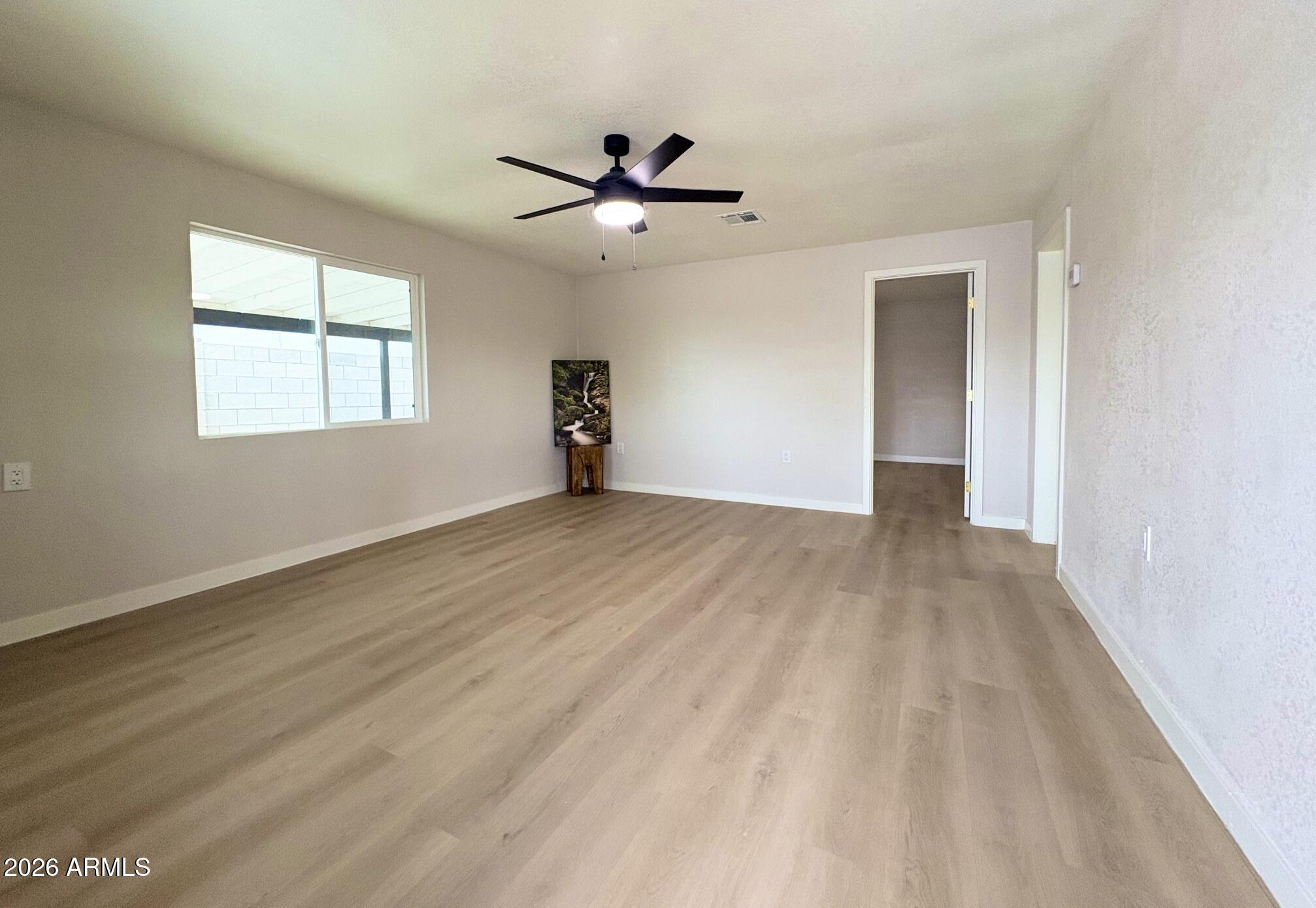 175 South Matilda Street Florence, AZ 85132 - Photo 5 of 16 wooden floor in an empty room with a window
