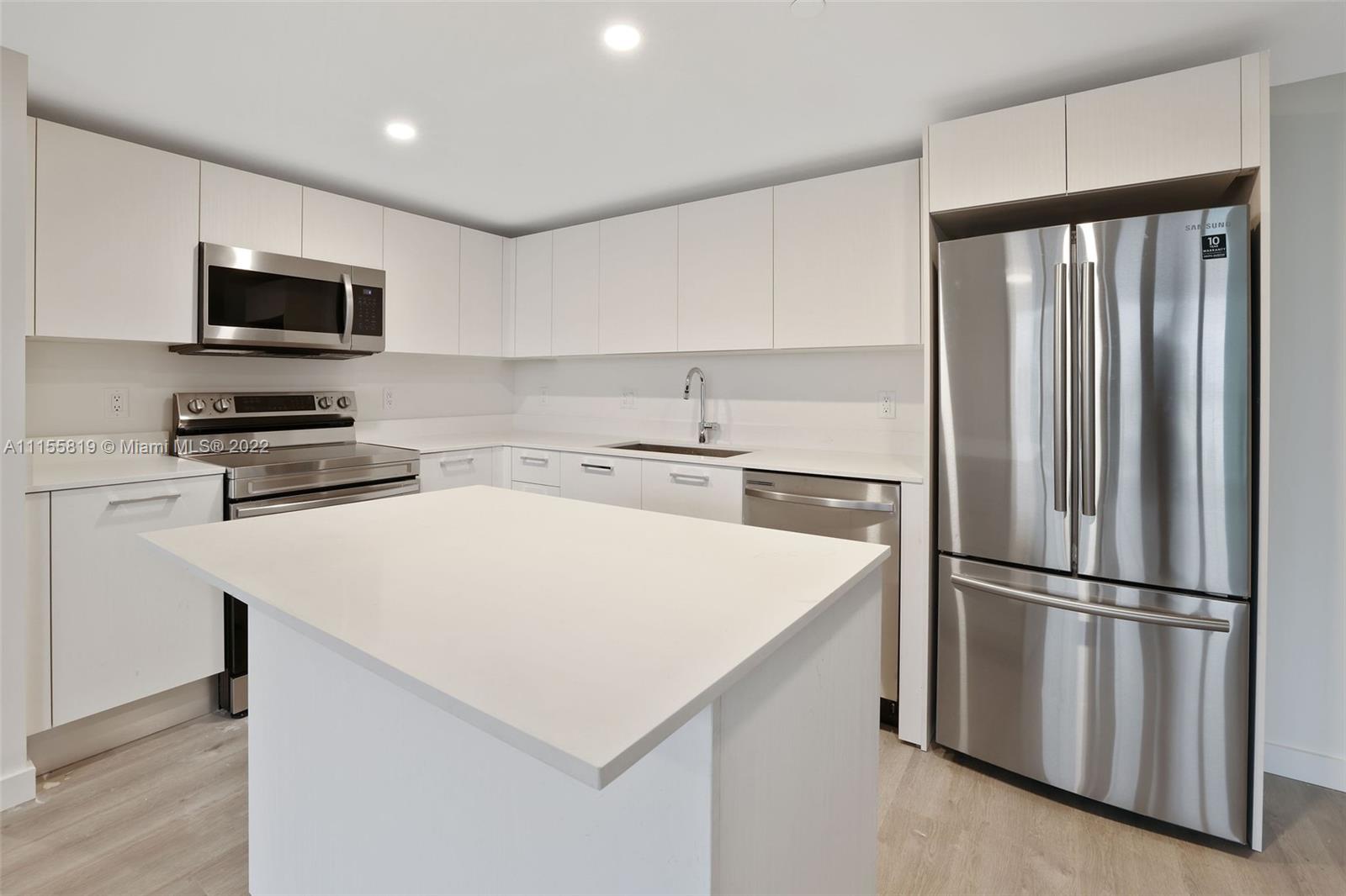 1504 Bay Road, Unit N1508 Miami Beach, FL 33139 - Photo 4 of 89 a kitchen with stainless steel appliances a refrigerator and a sink