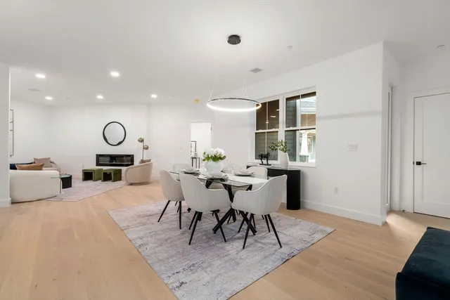 a living room with furniture a rug and a large window