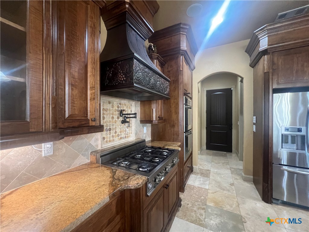 523 Messer Ranch Road Belton, TX 76513 - Photo 11 of 40 a kitchen with stainless steel appliances granite countertop a stove and a refrigerator
