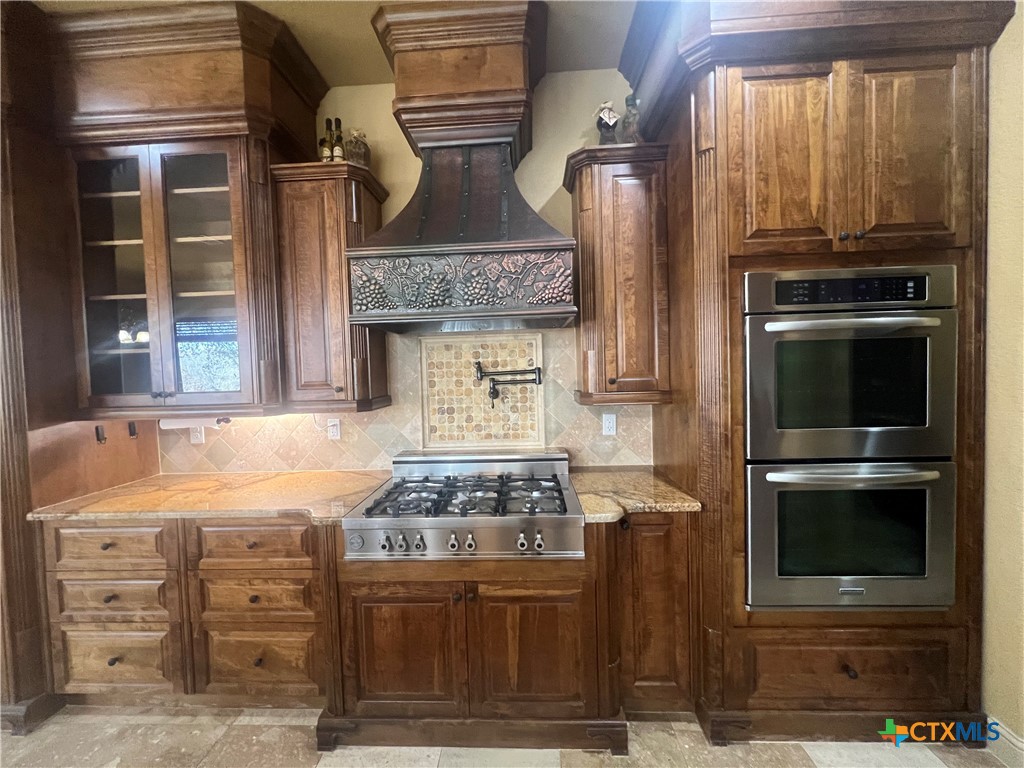 523 Messer Ranch Road Belton, TX 76513 - Photo 12 of 40 a kitchen with stainless steel appliances granite countertop a stove and a refrigerator