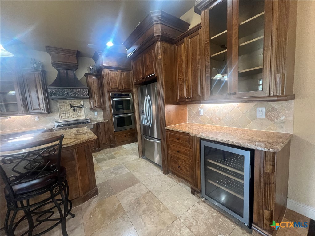 523 Messer Ranch Road Belton, TX 76513 - Photo 13 of 40 a kitchen with a stove and a refrigerator