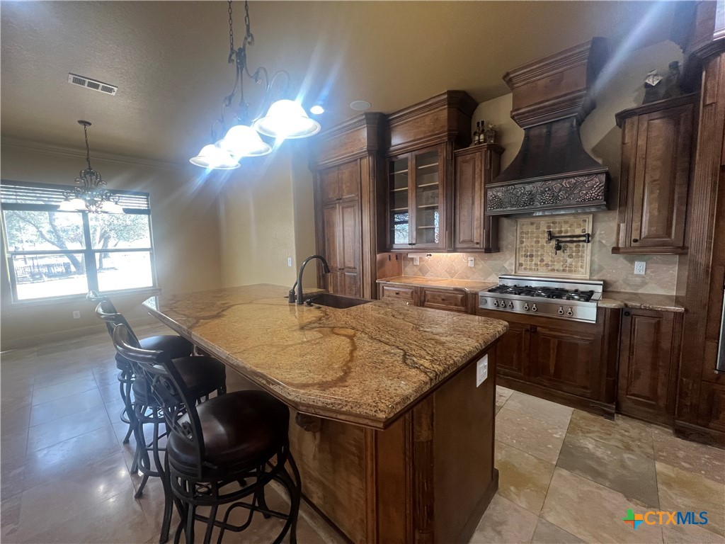 523 Messer Ranch Road Belton, TX 76513 - Photo 15 of 40 a kitchen with stainless steel appliances granite countertop a stove a sink a refrigerator and a wooden cabinets