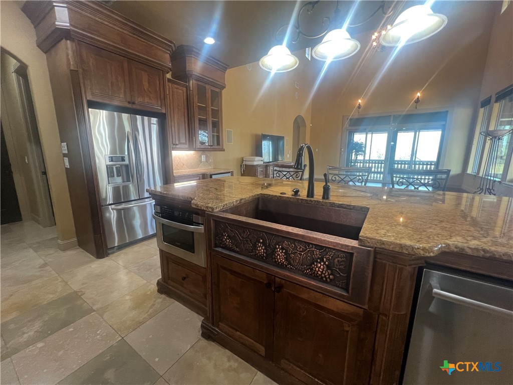 523 Messer Ranch Road Belton, TX 76513 - Photo 16 of 40 a kitchen with stainless steel appliances granite countertop a sink a stove and a refrigerator