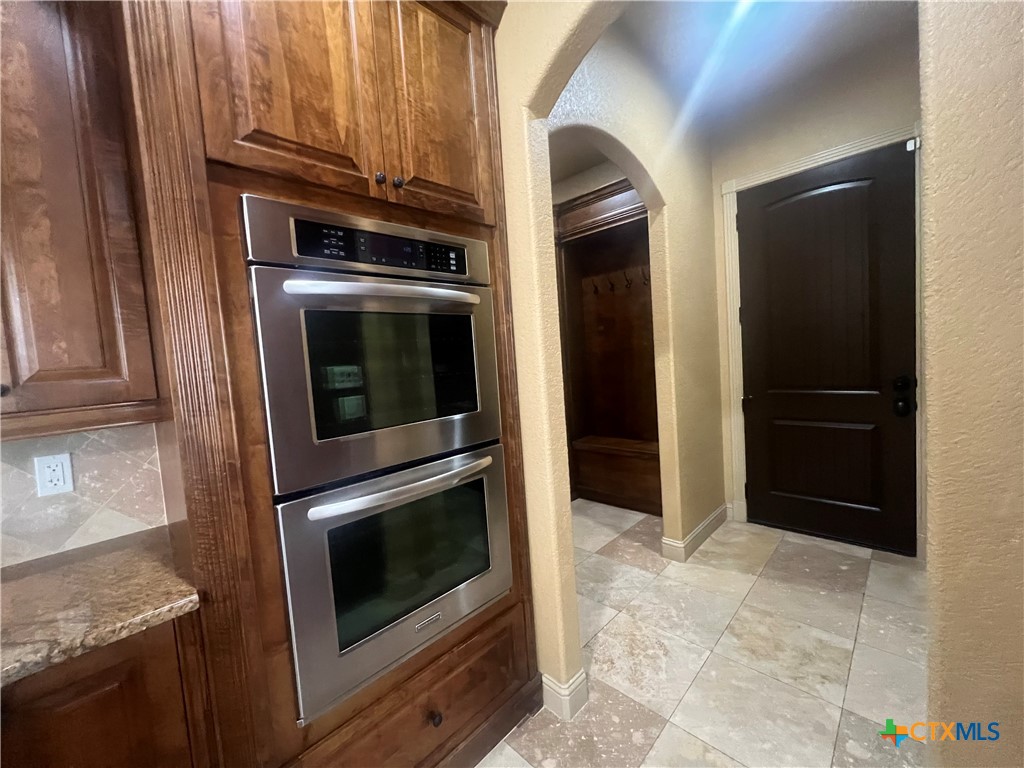 523 Messer Ranch Road Belton, TX 76513 - Photo 17 of 40 a kitchen with granite countertop white cabinets and stainless steel appliances